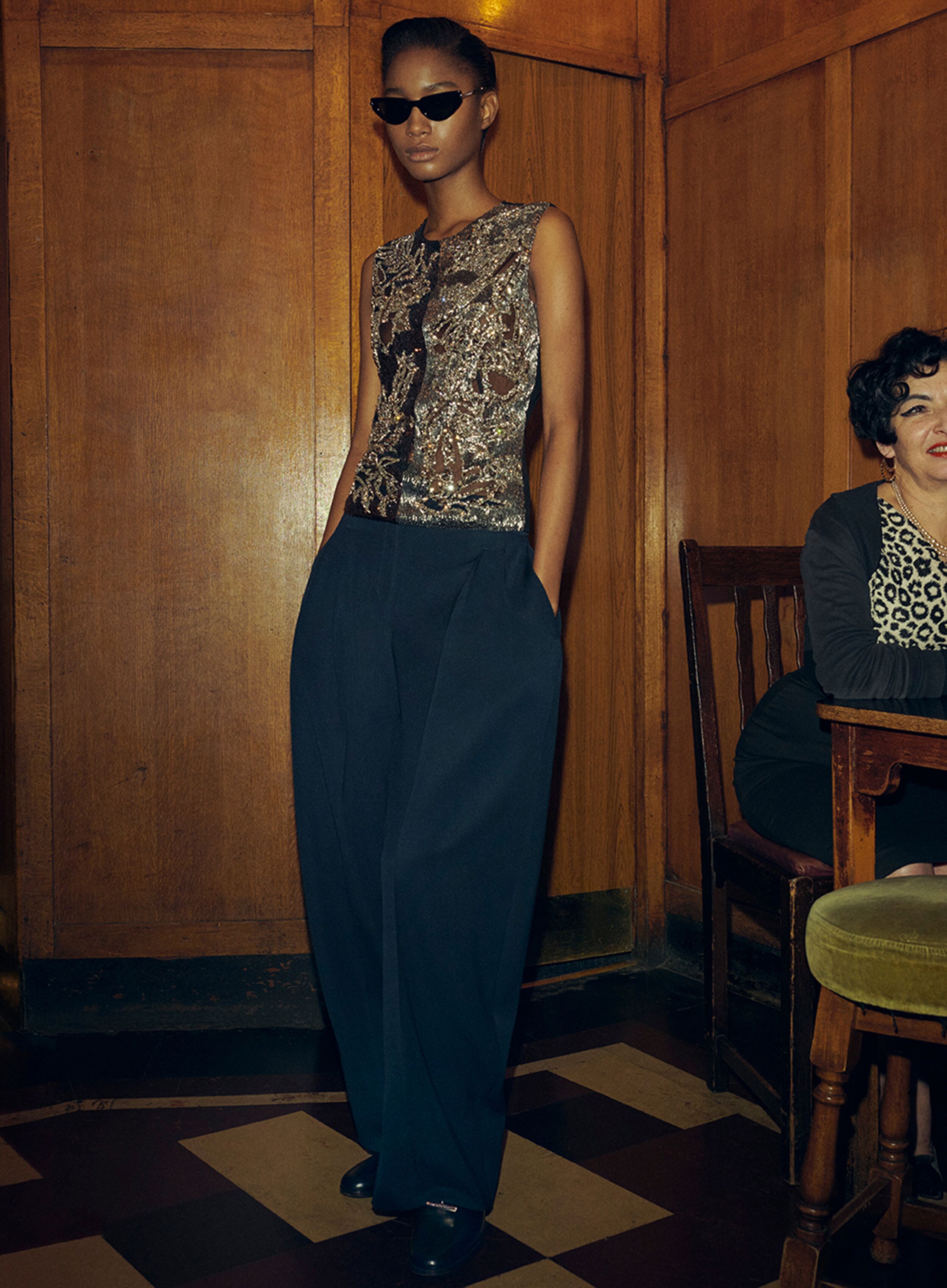 Women in a embellished black McQueen evening top