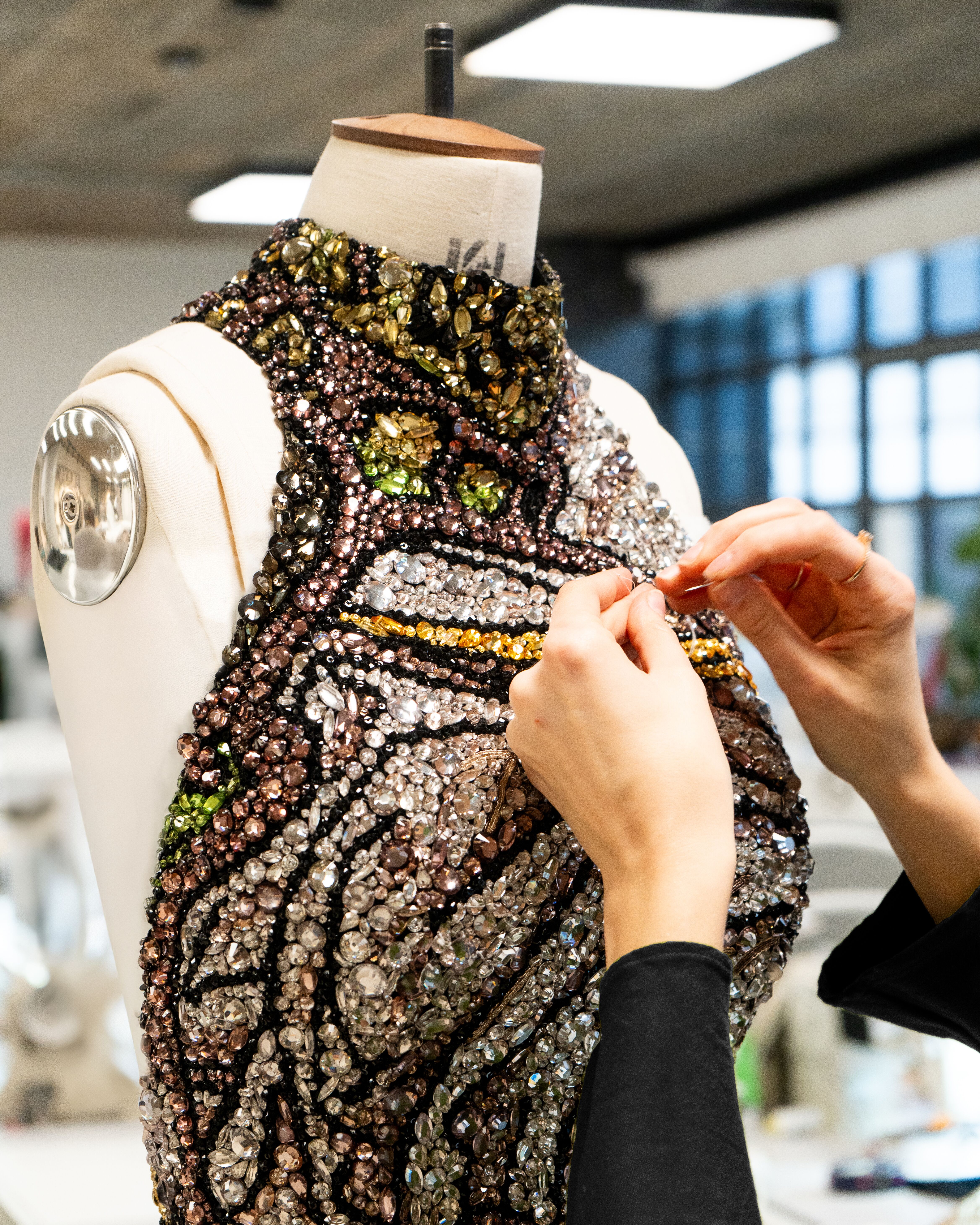 Hand embroidery on mannequin in studio environment