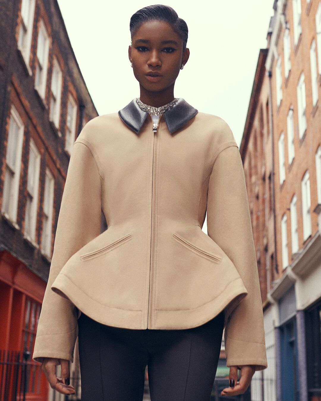 Model wearing matching Alexander McQueen tailored jacket and skirt