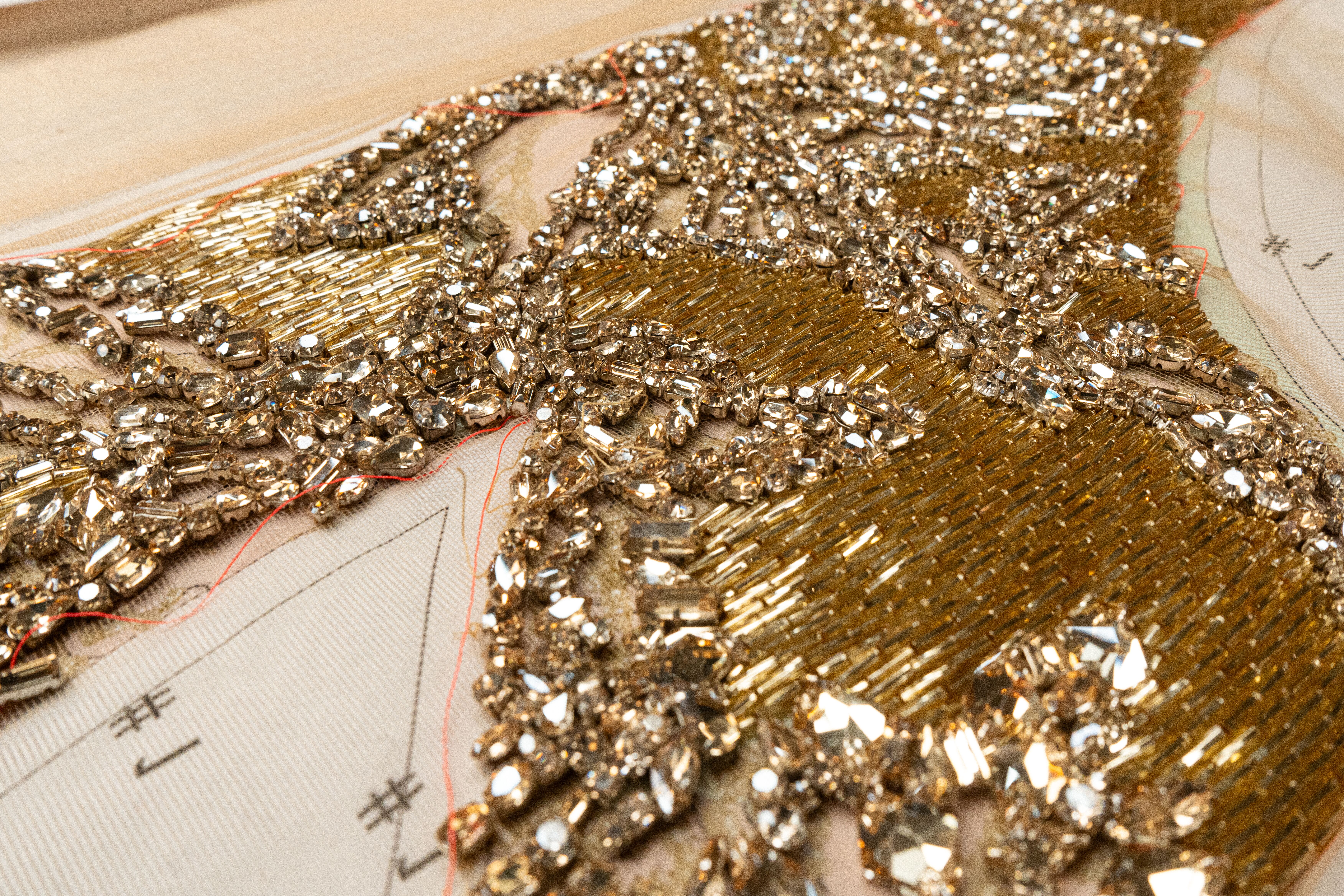 Gold toned embroidery close up in McQueen Atelier