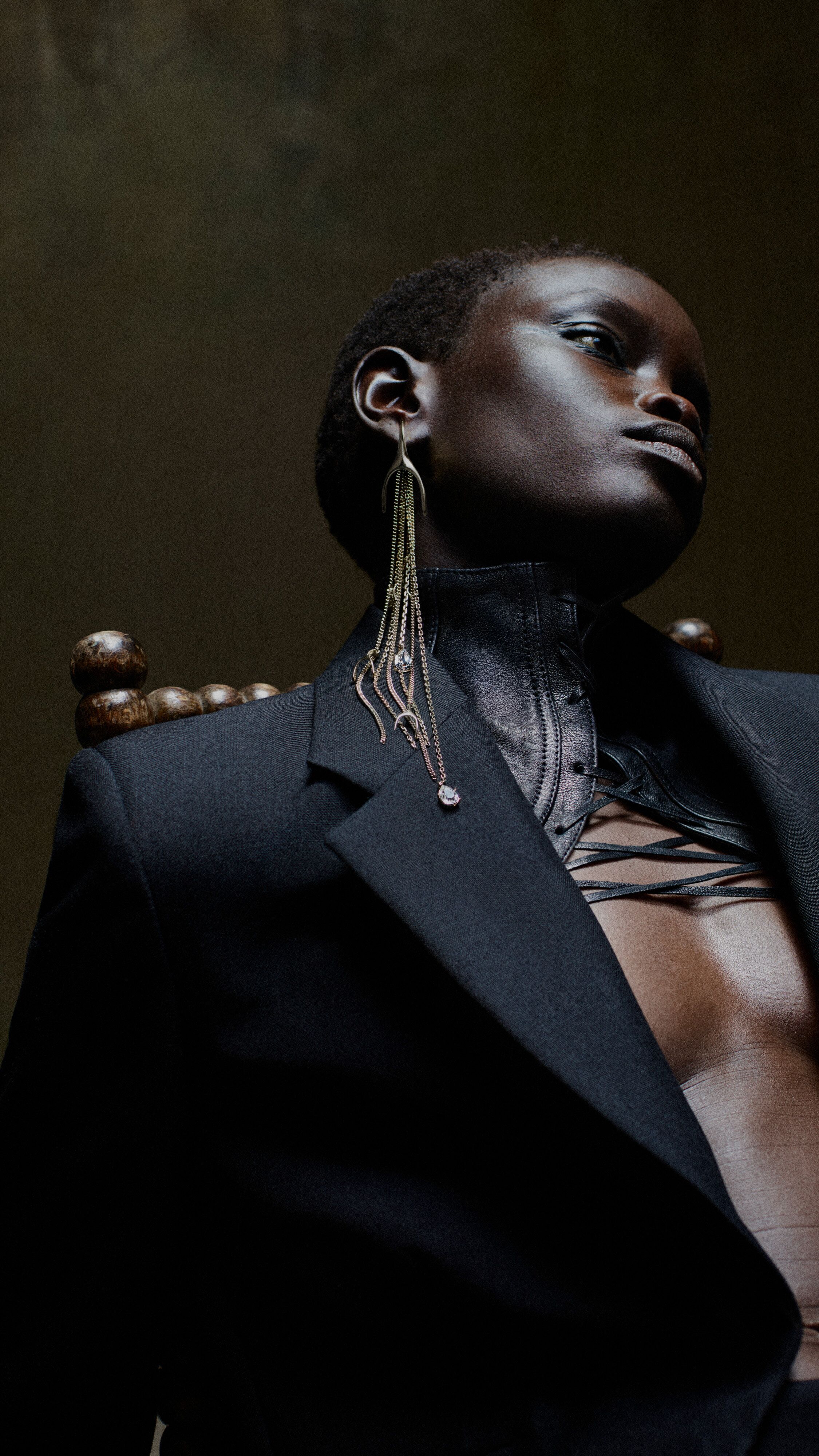 Women wearing a necklace and earrings by McQueen