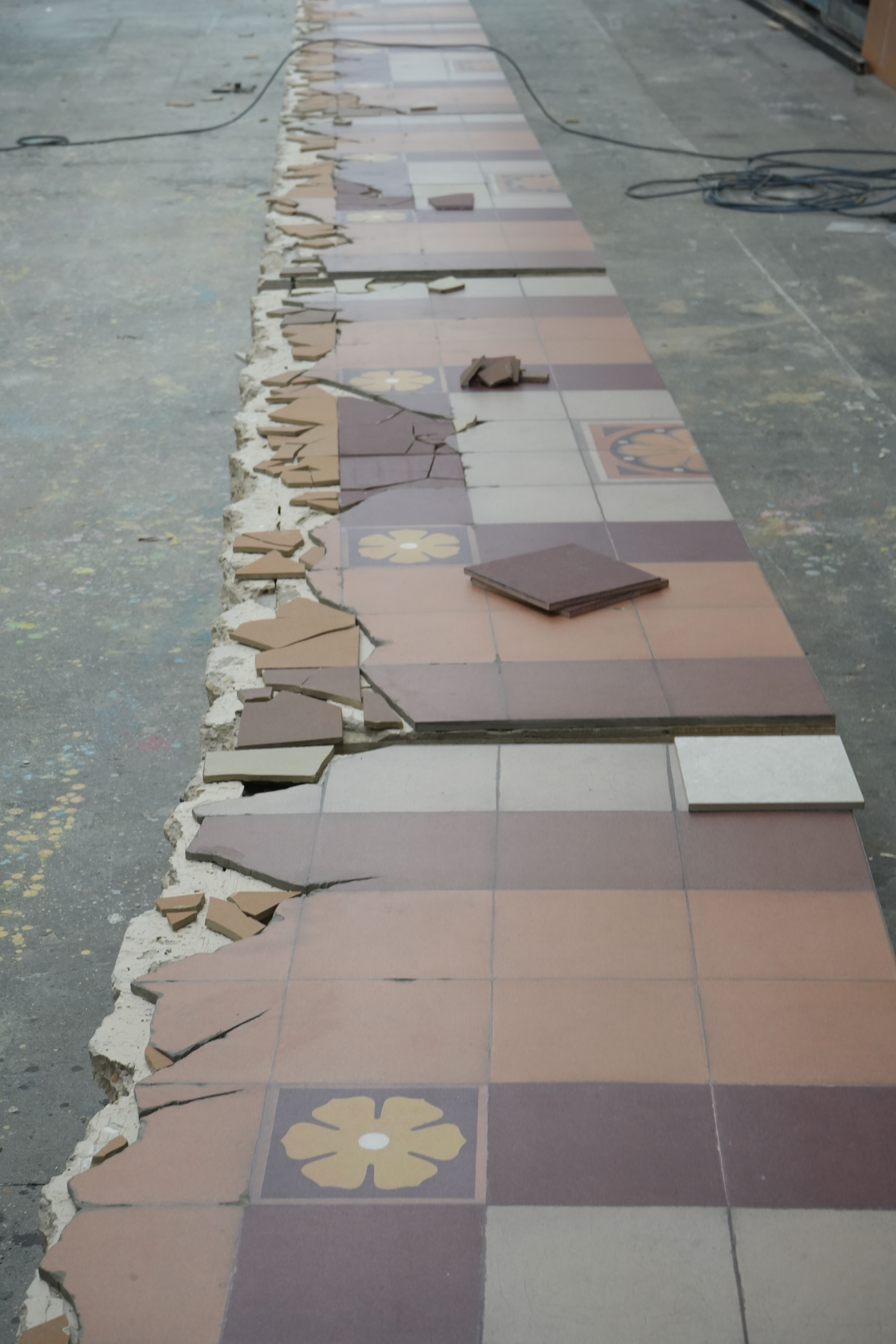 Close up of Tiled Flooring being created for the McQueen Spring Summer 2025 show at École des Beaux-Arts