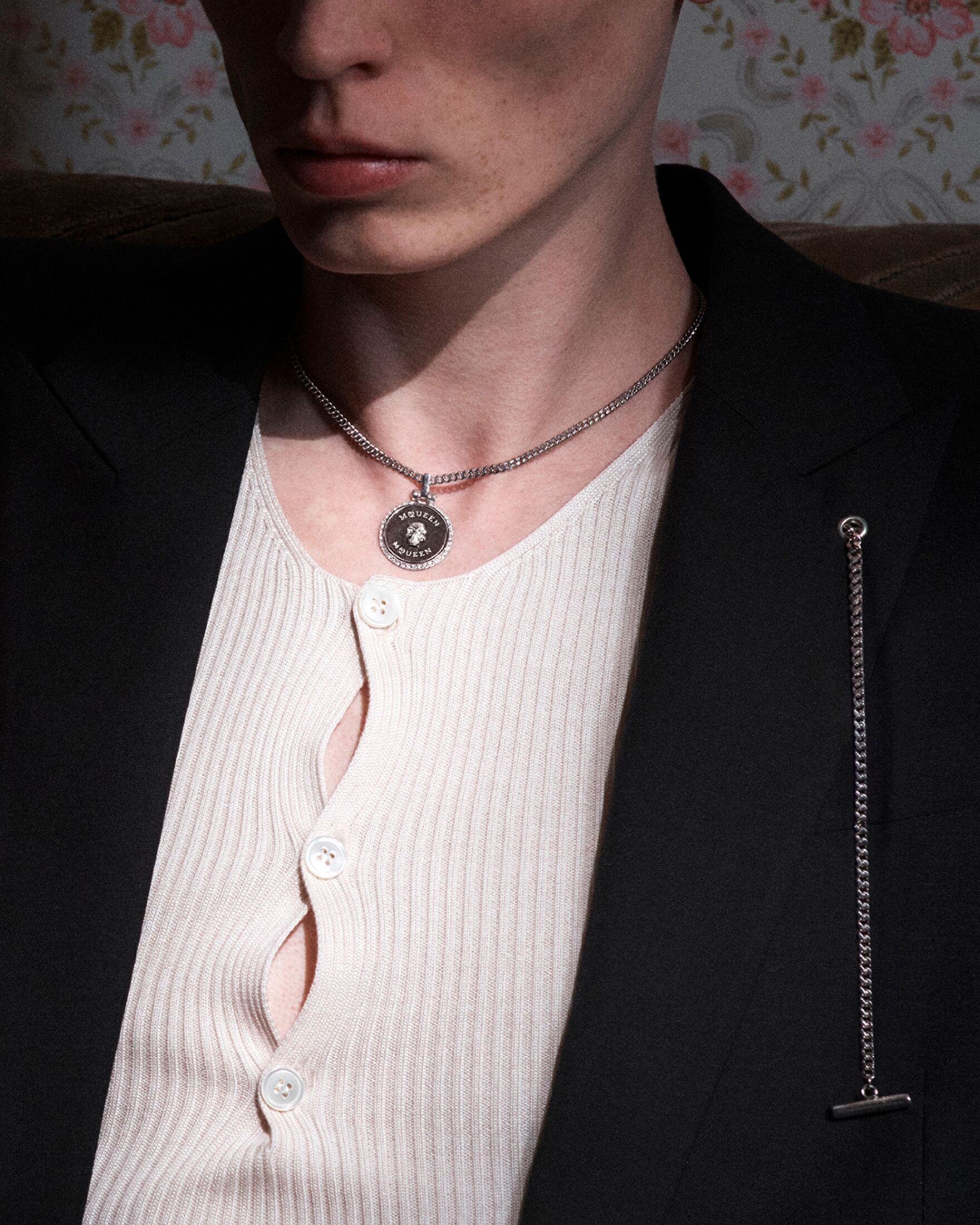 Man wearing a McQueen necklace