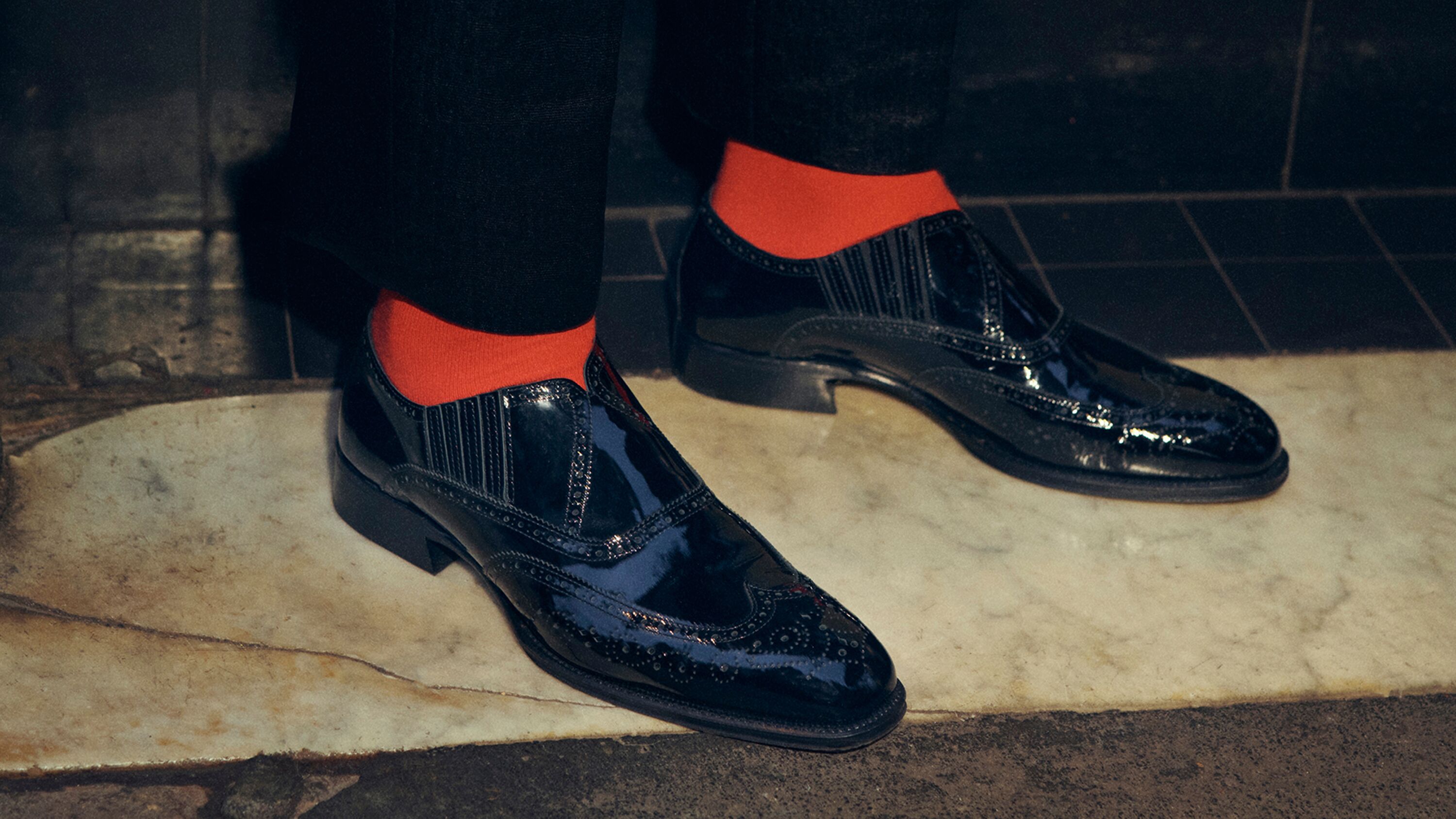 Black  dress shoes and red McQueen socks