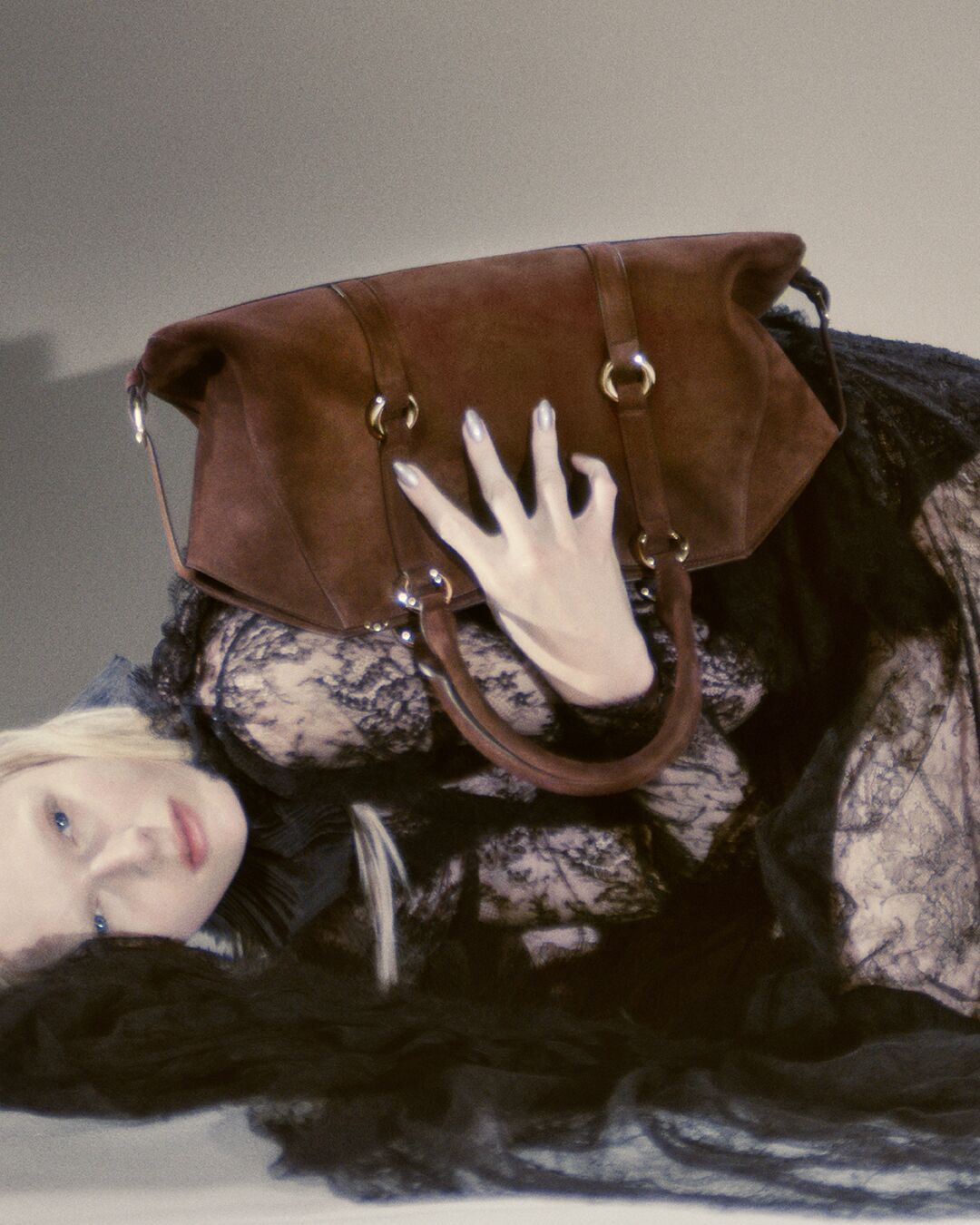 Women holding a brown suede Farringdon bag
