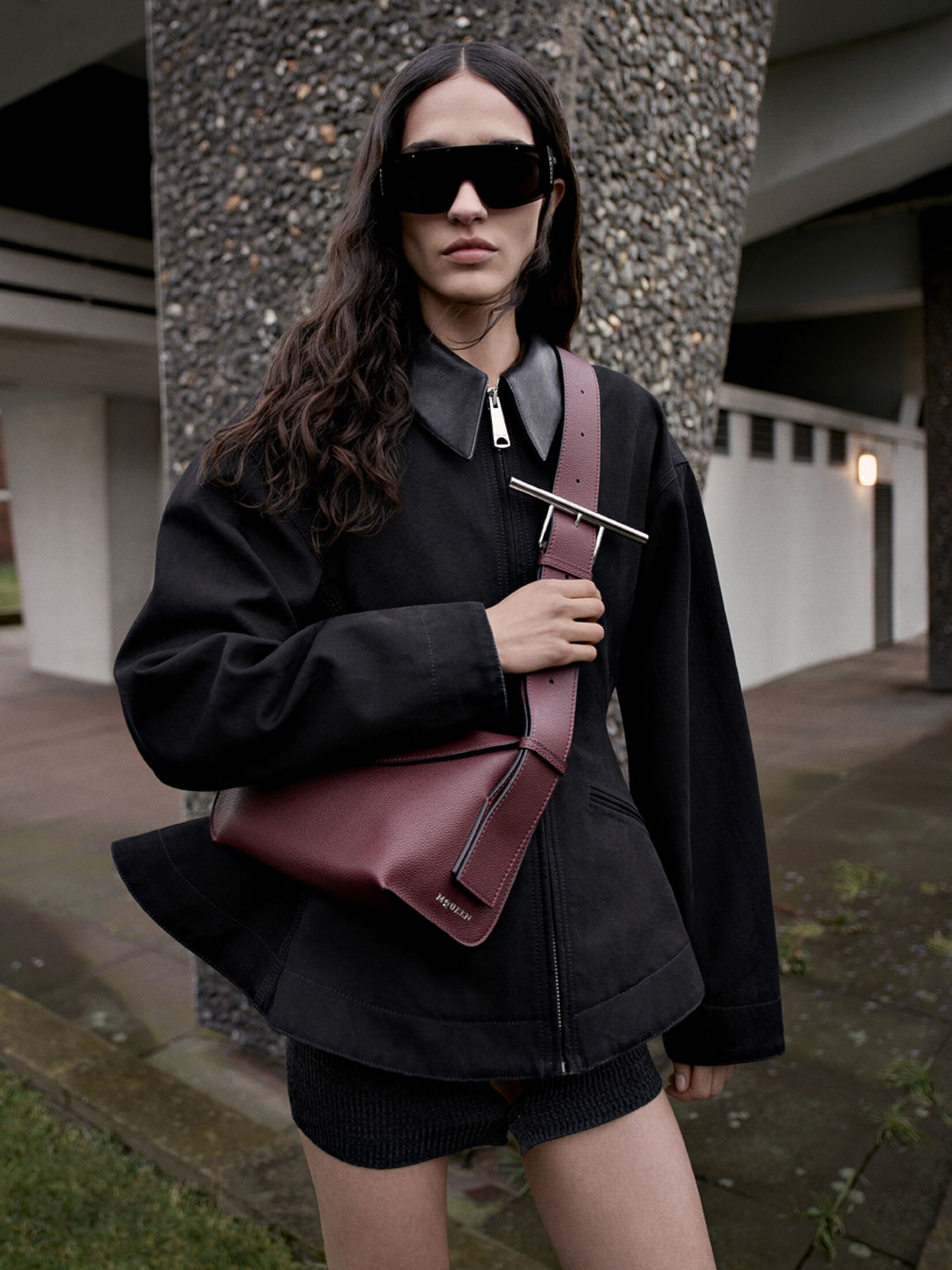 Women carrying a cross body burgundy bag