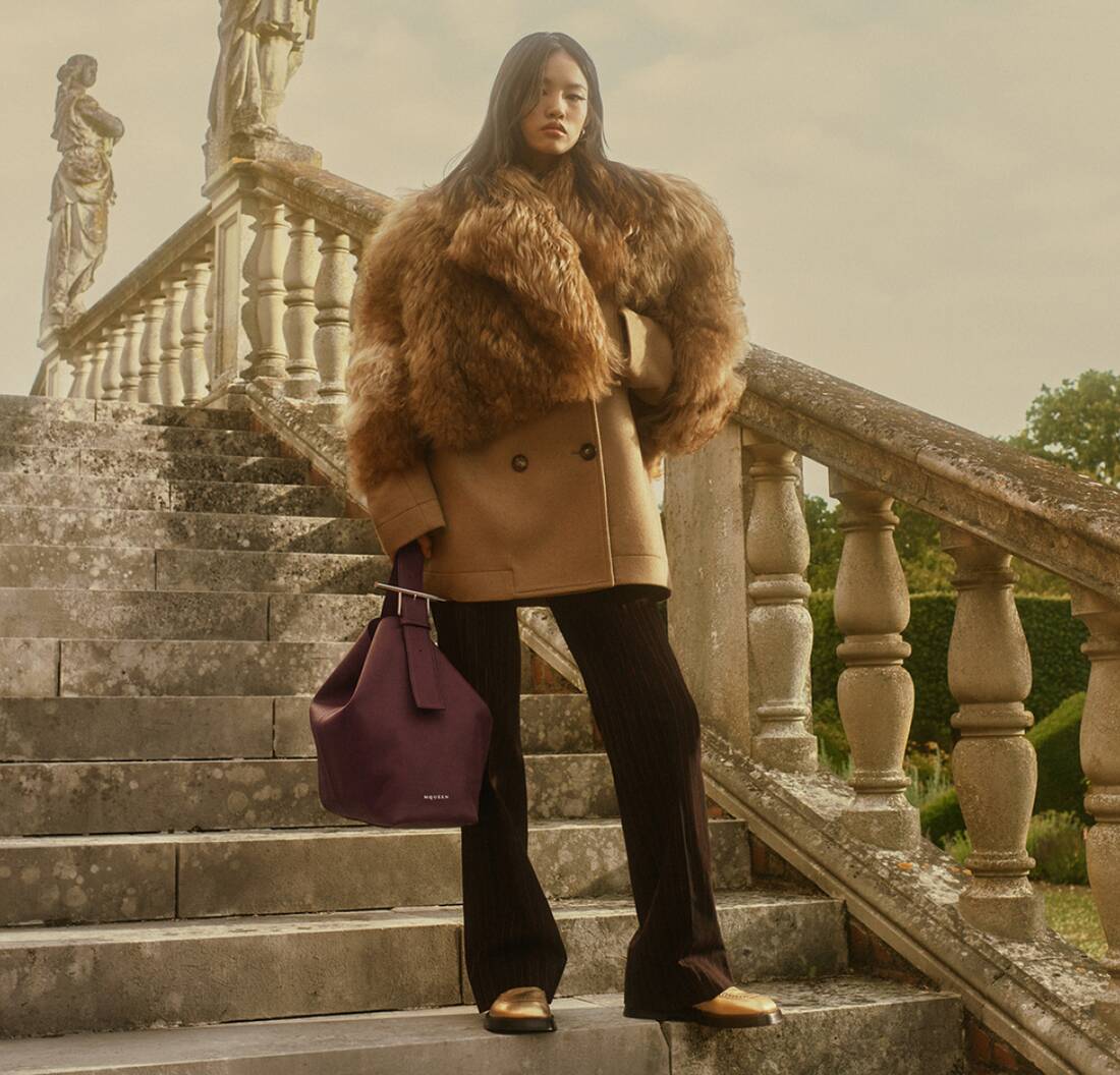 Model wearing red tartan skirt and a coat