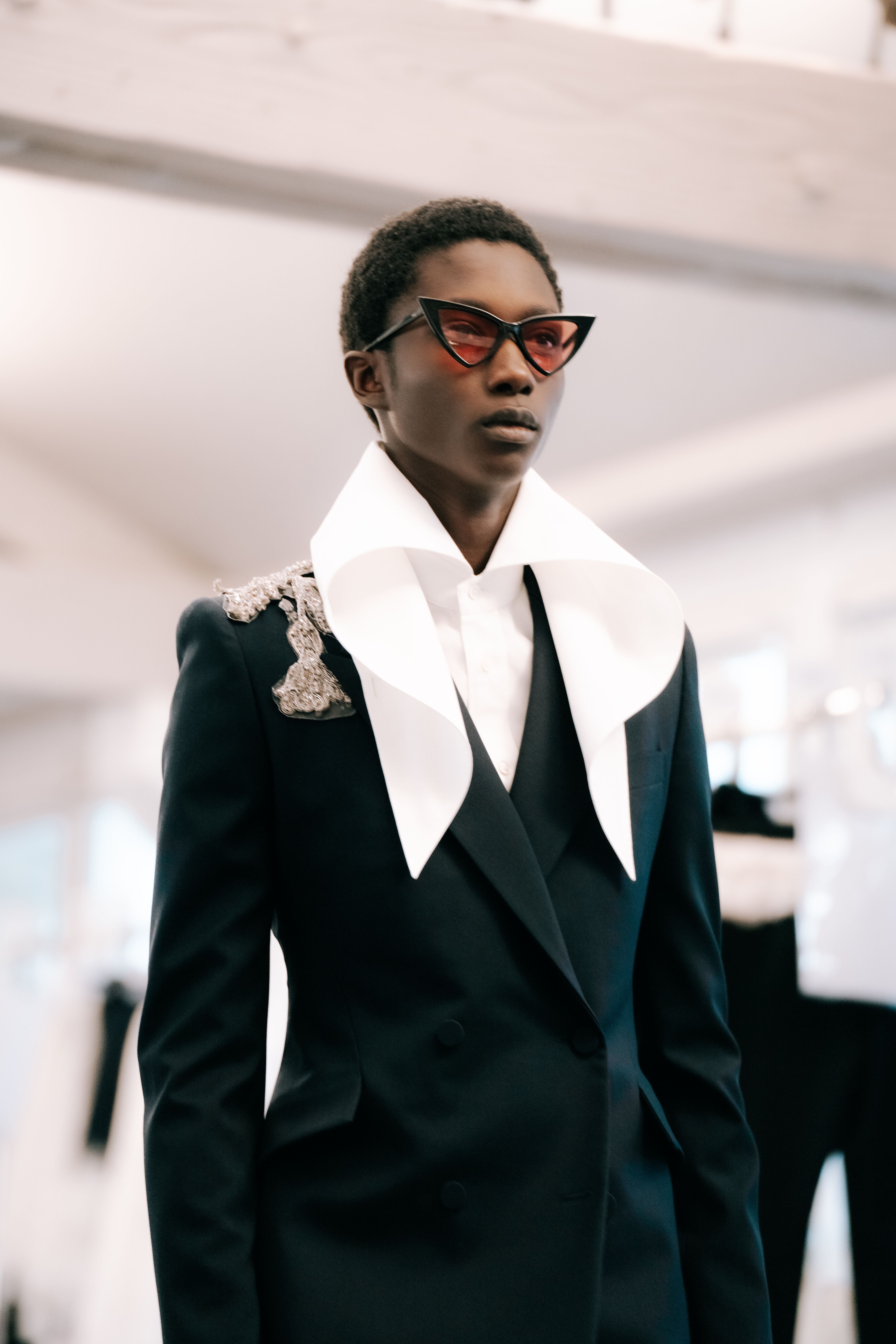 A model in a suit inside McQueen atelier