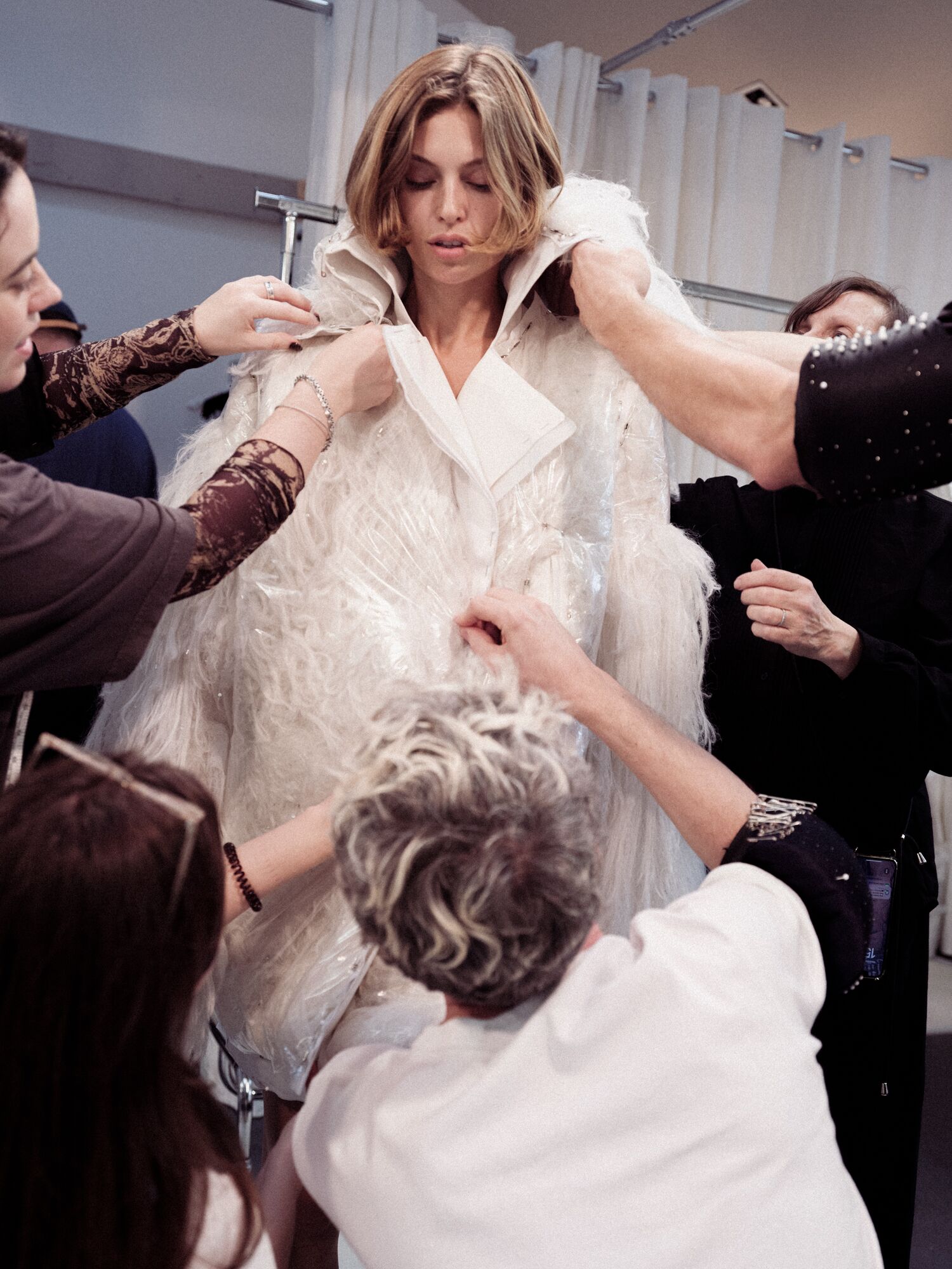 McQueen atelier team making tweaks to Banshee Hair dress in Paris before the Spring Summer 2025 show. 