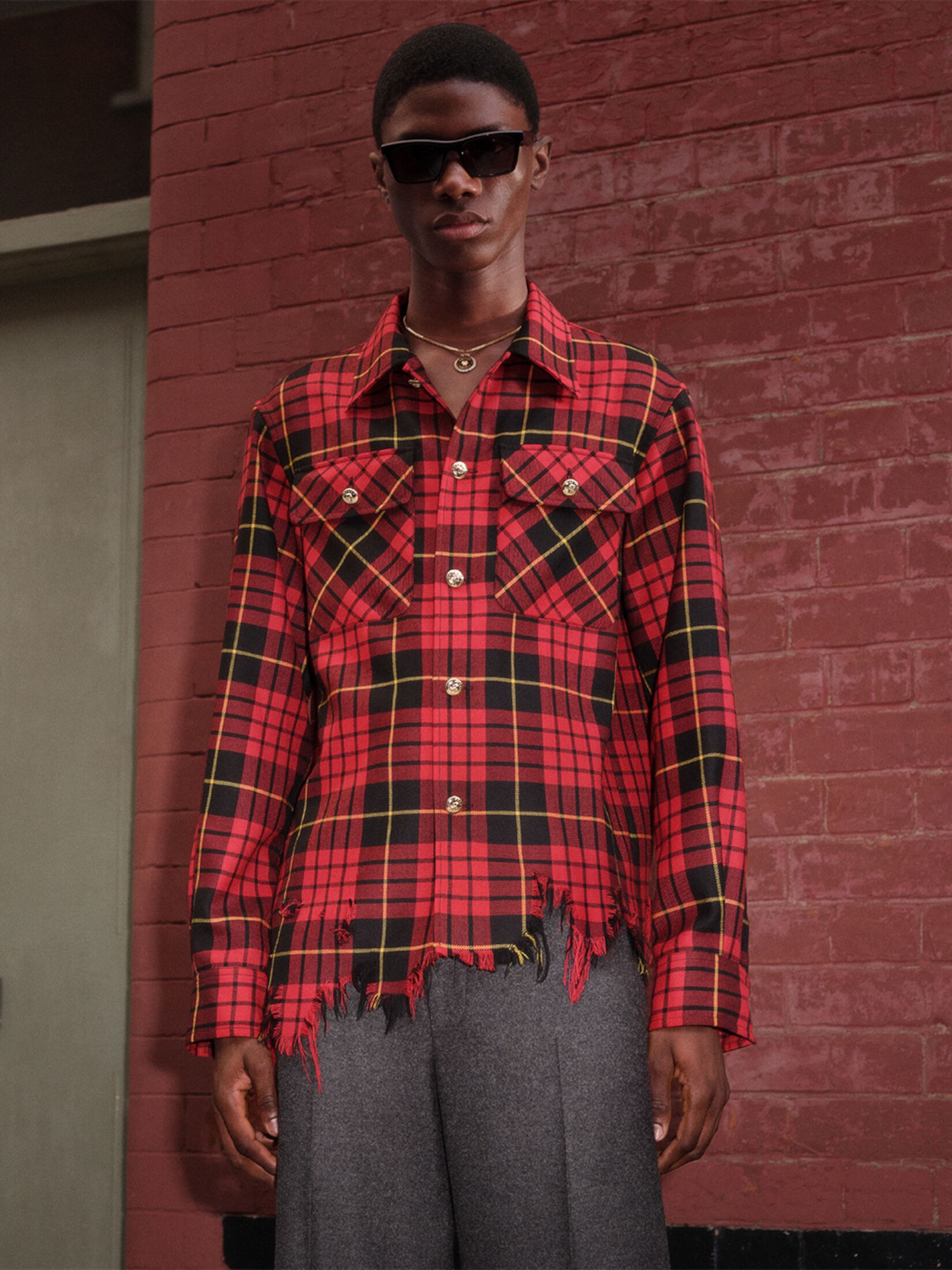 Man in a McQueen tartan shirt