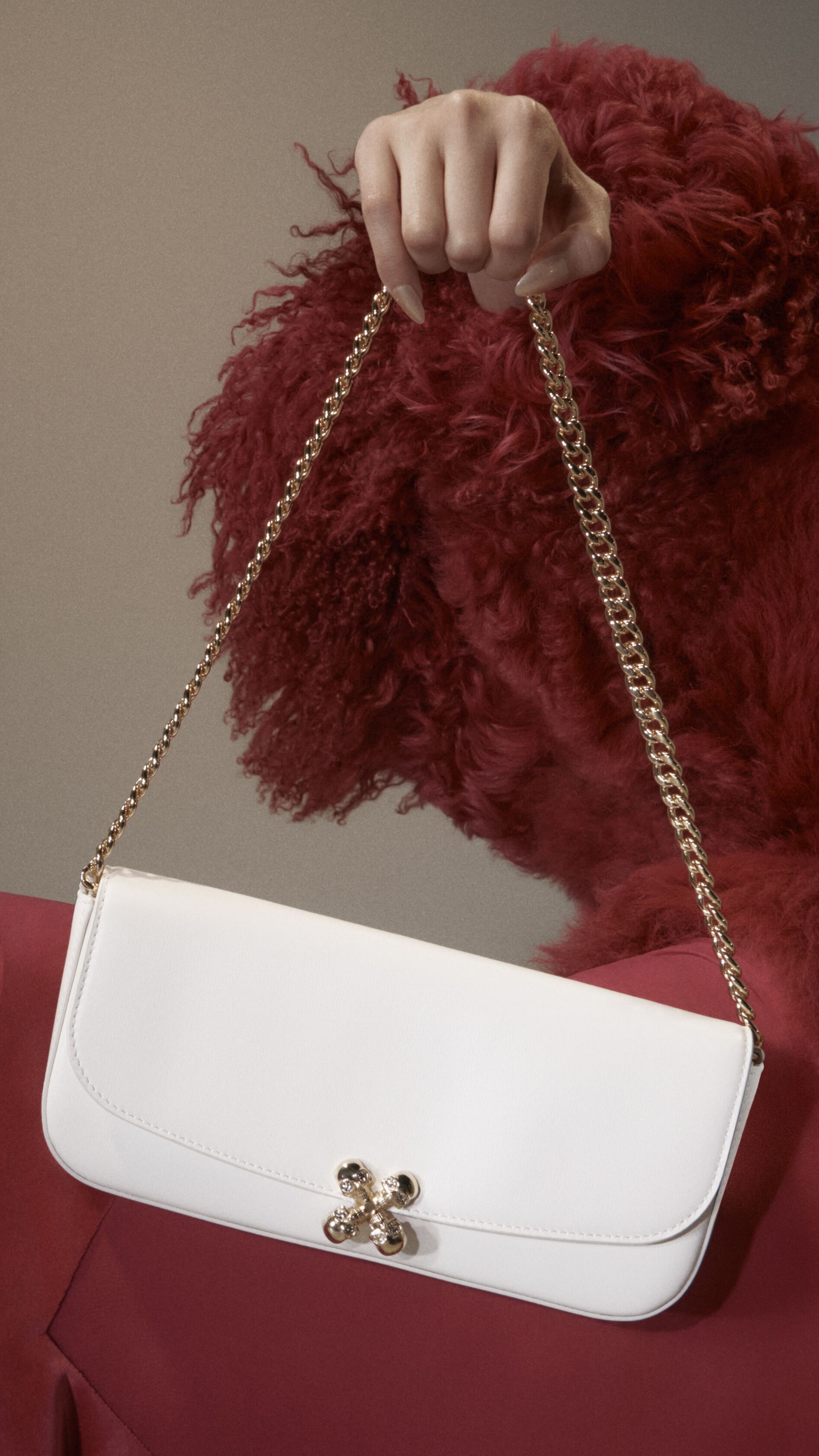 Women holding a McQueen Skull Flower Bag in white