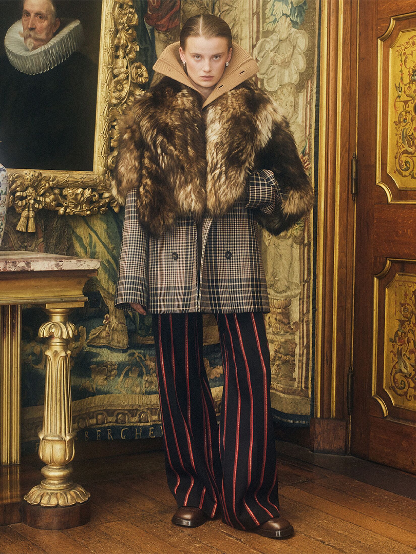 Women in McQueen shearling coat and tailored trousers