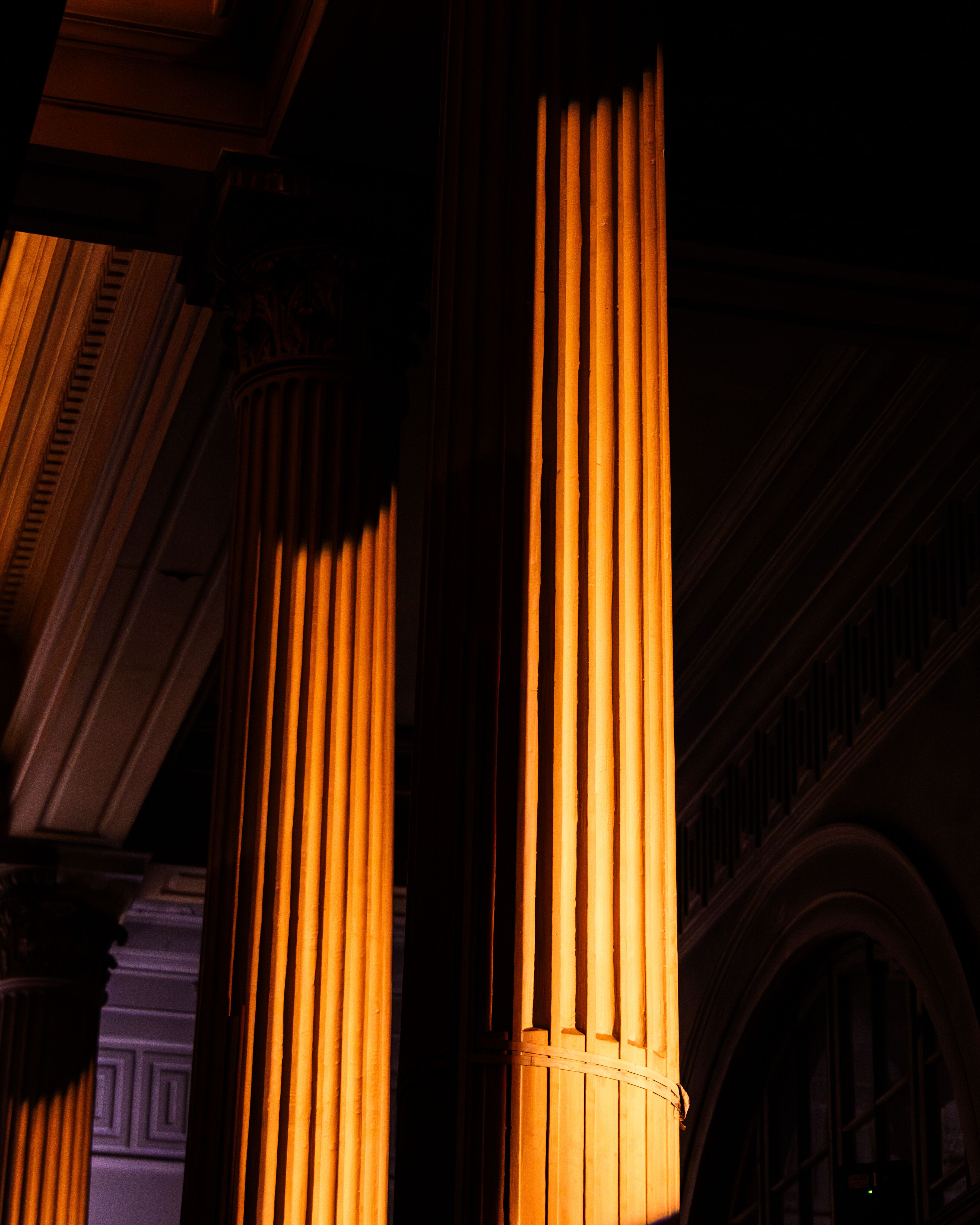 Pillars lit with a warm light at McQueen Autumn Winter 2025 Show