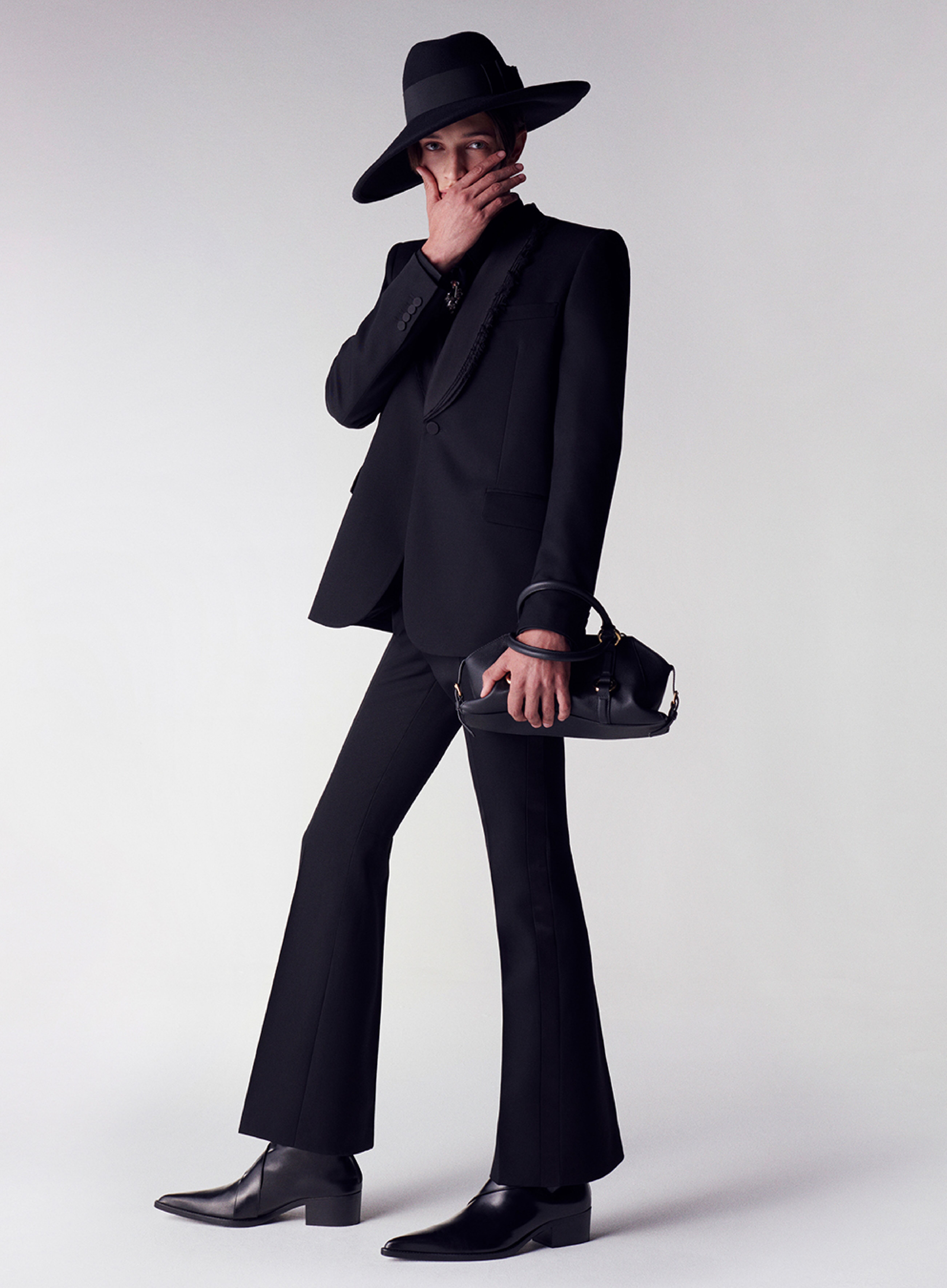 Man in a McQueen black tailored suit and Farringdon nag