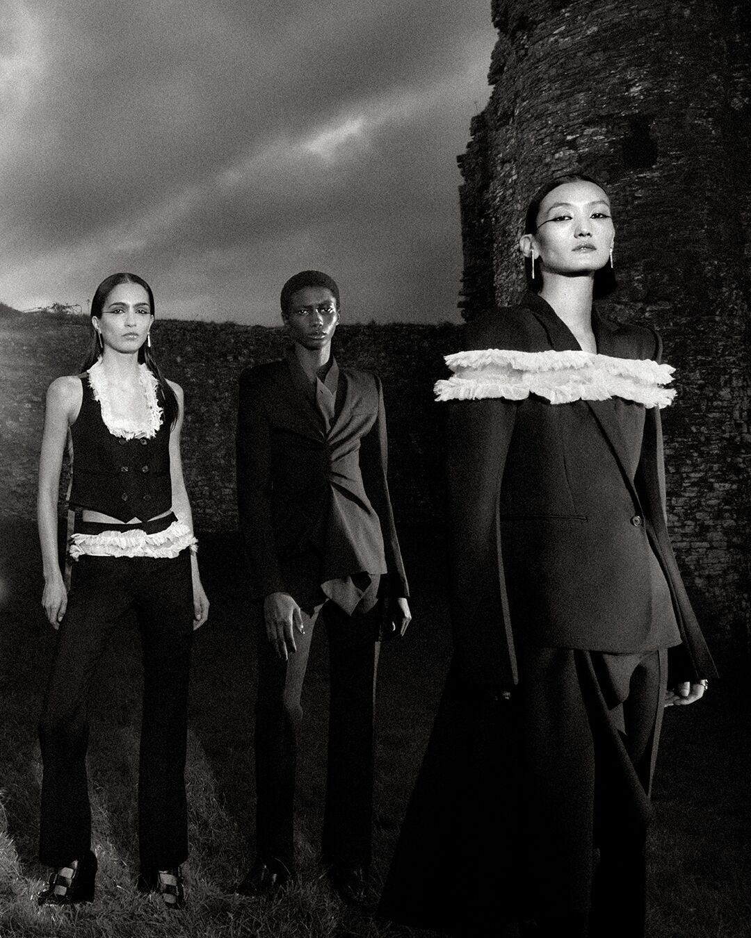 Black and White Image of Models on location at Llansteffan Castle for McQueen Spring Summer 2025 Campaign