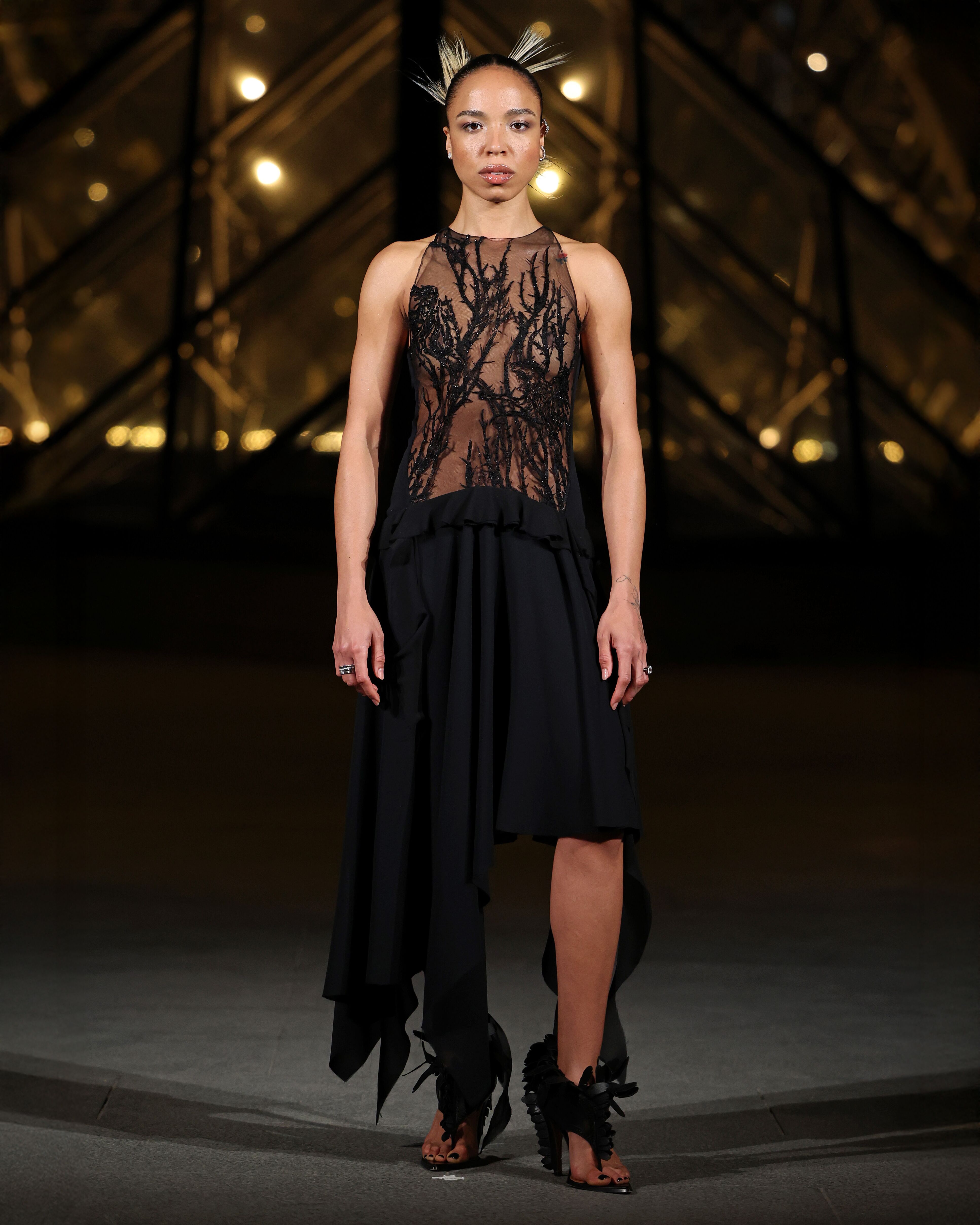 Zsela wearing hawthorn embroidered black McQueen dress with leather feathered heels