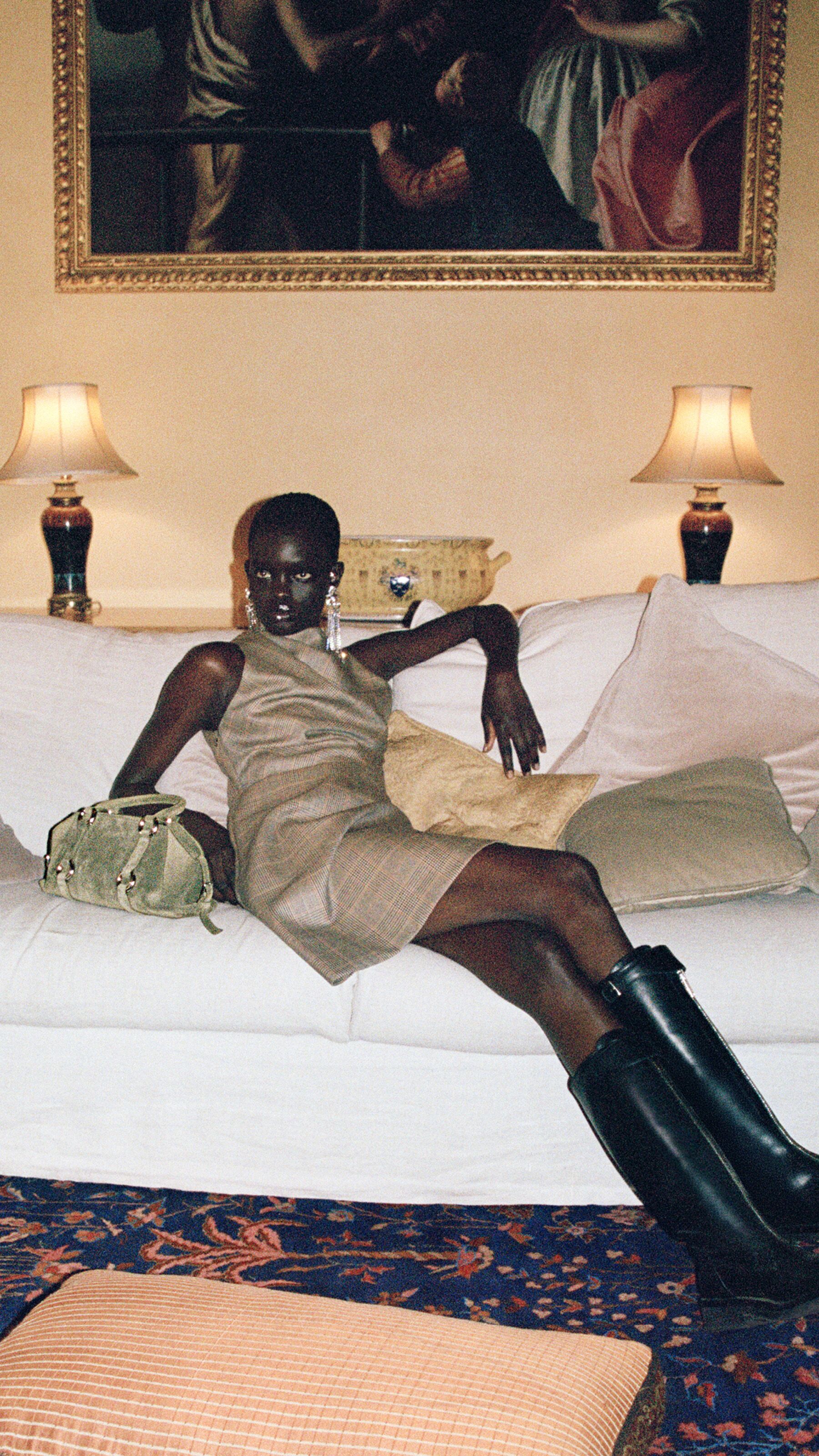 Women in McQueen country check dress and knee high boots