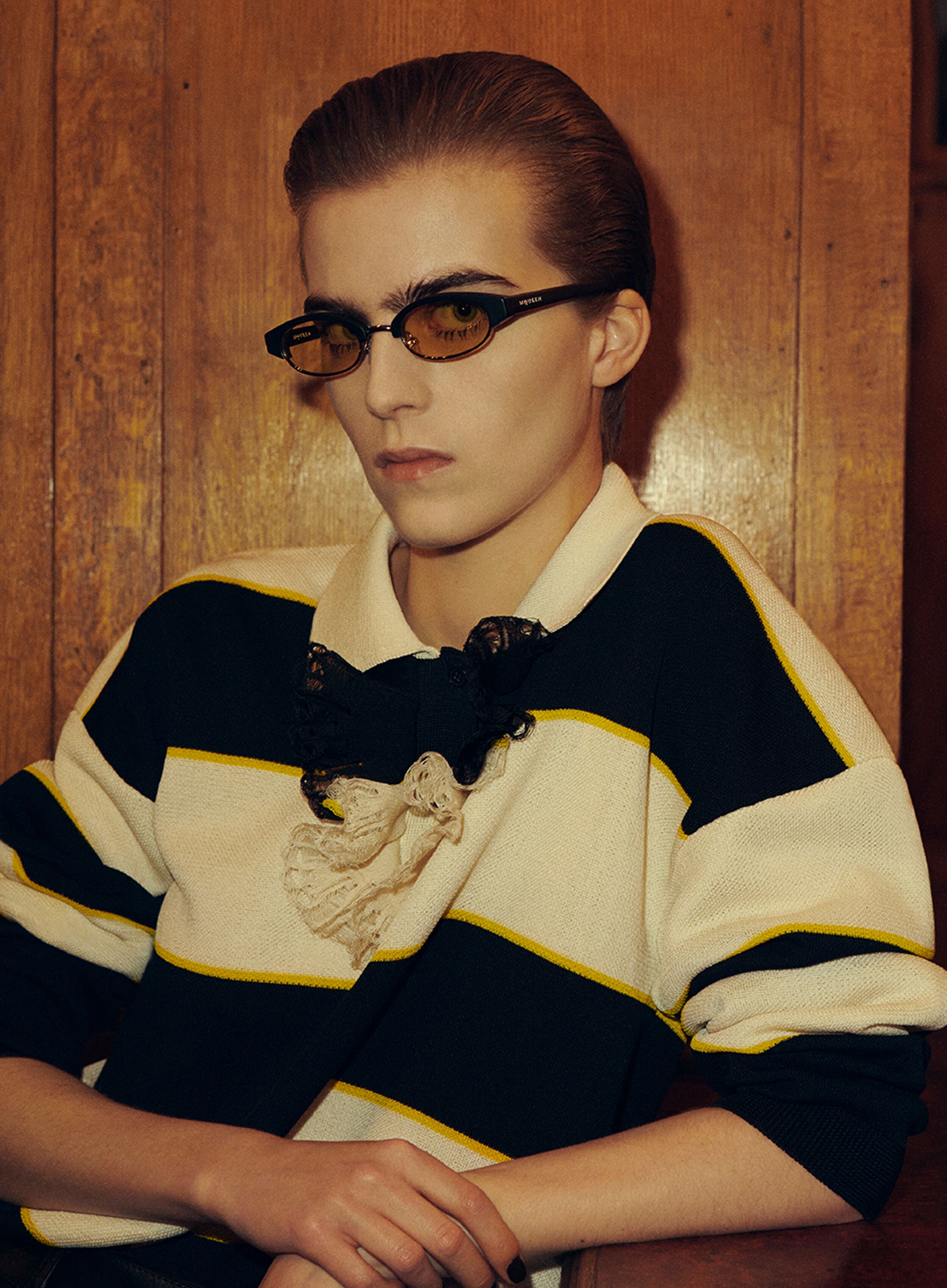 Women in McQueen Sunglasses and McQueen rugby shirt