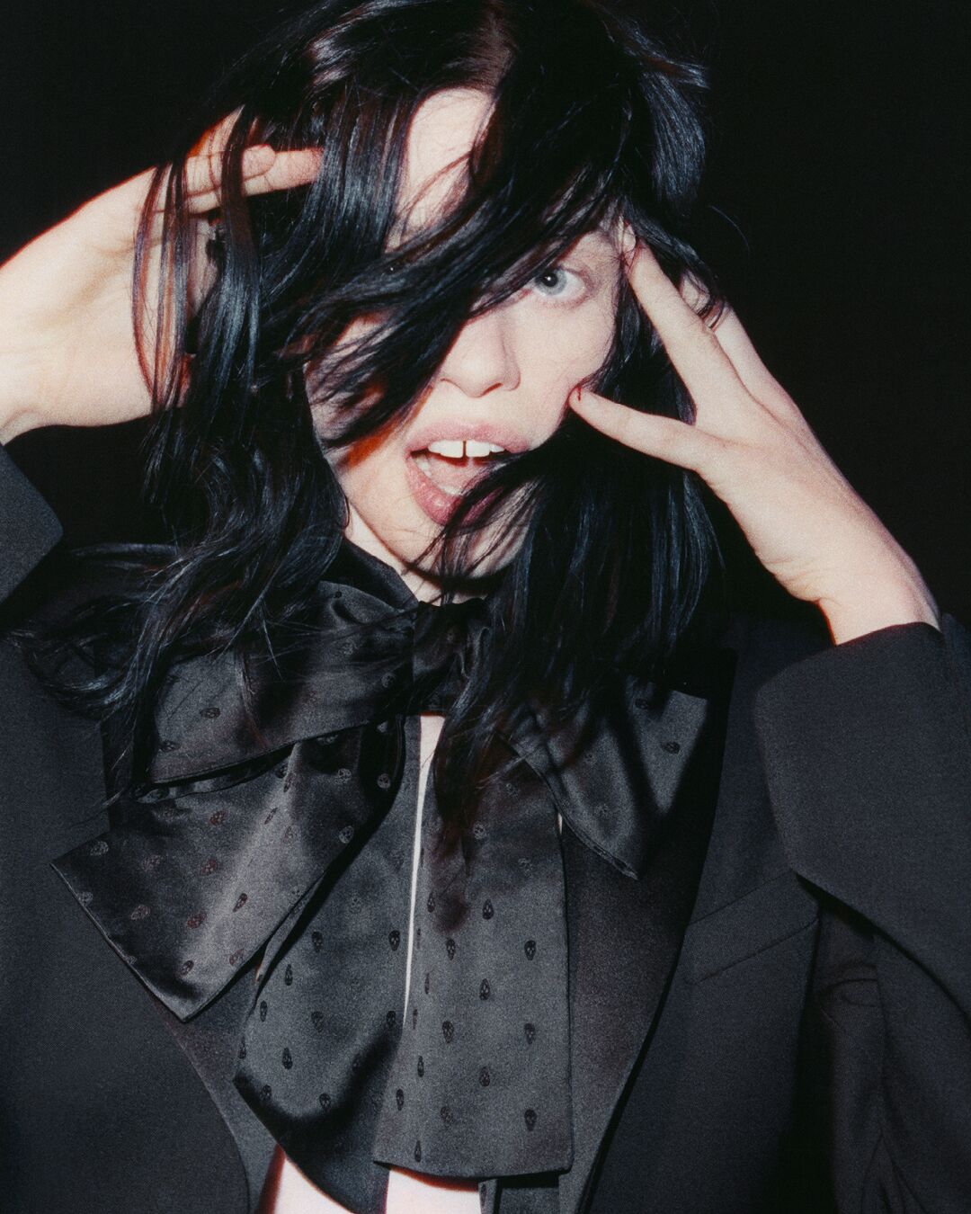 A person with black hair and wearing a necktie 