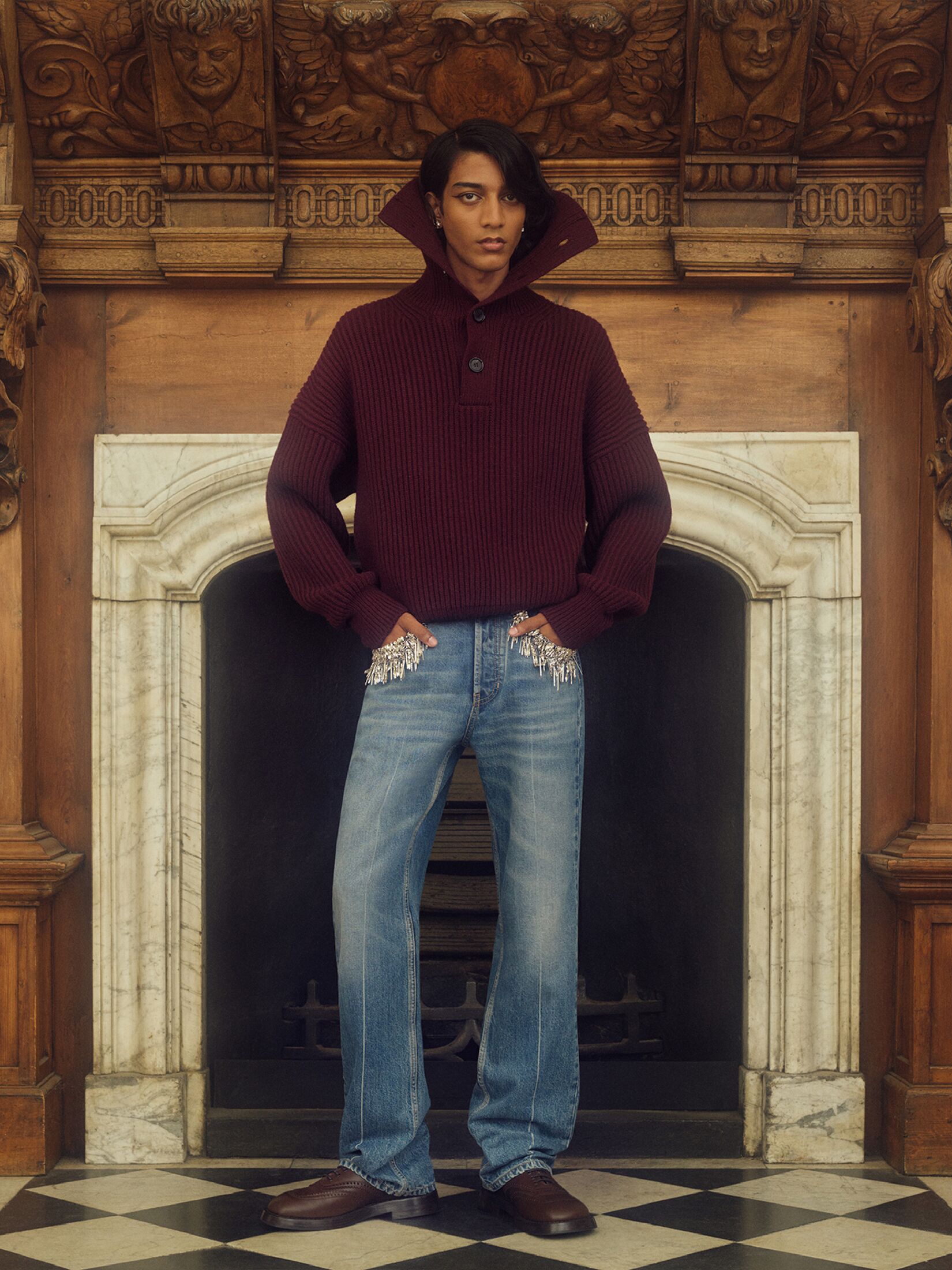 Man in a burgundy knitted sweatshirt with exaggerated collar