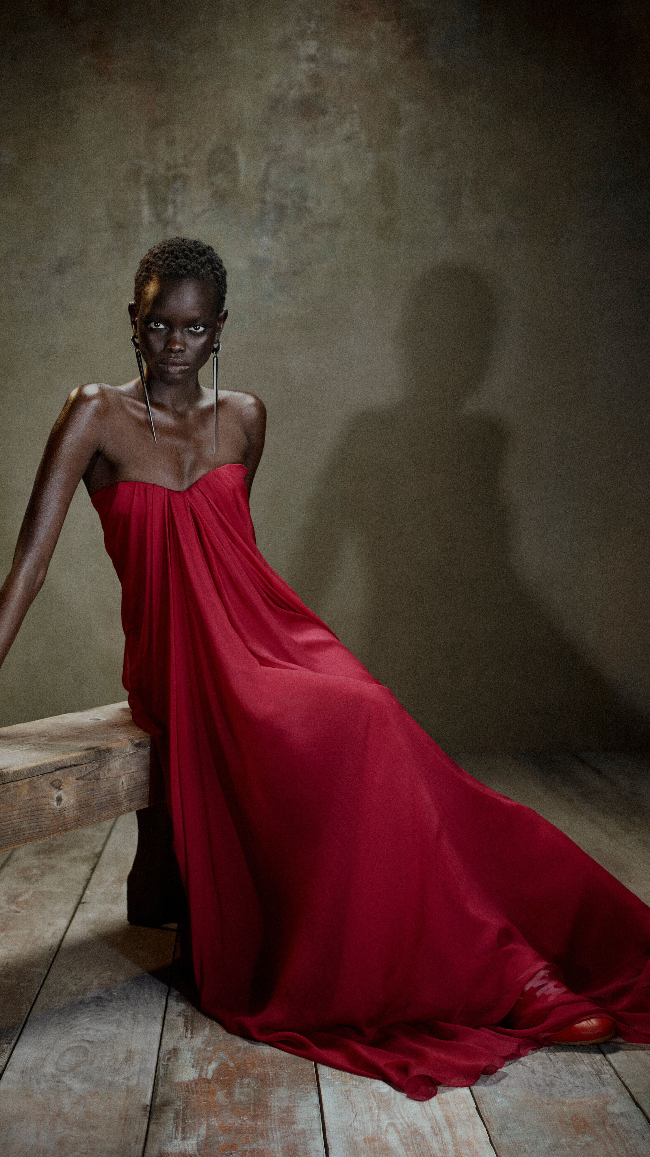 Women in McQueen red evening dress