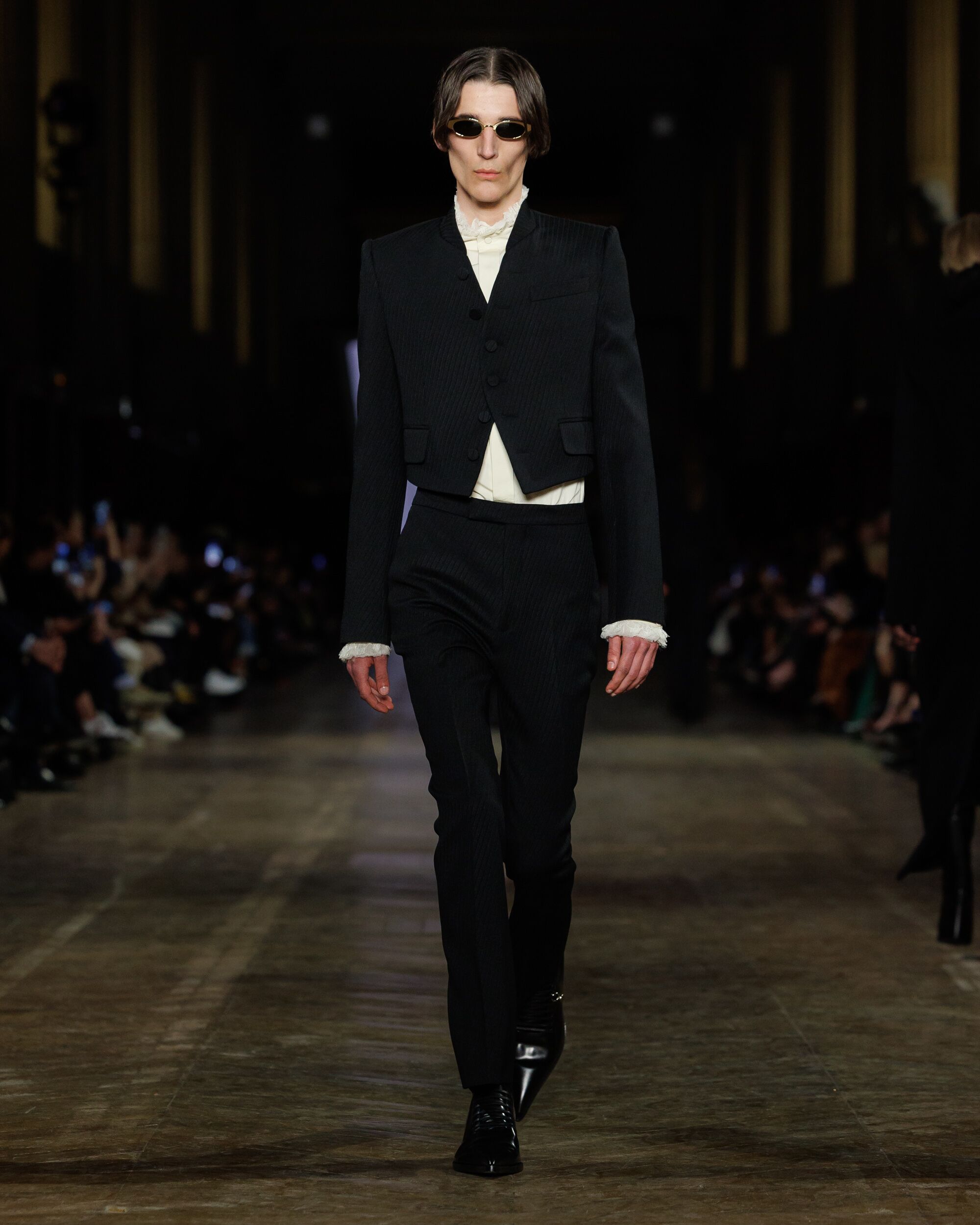 Model wearing Victorian inspired tailoring on runway McQueen Autumn Winter 2025