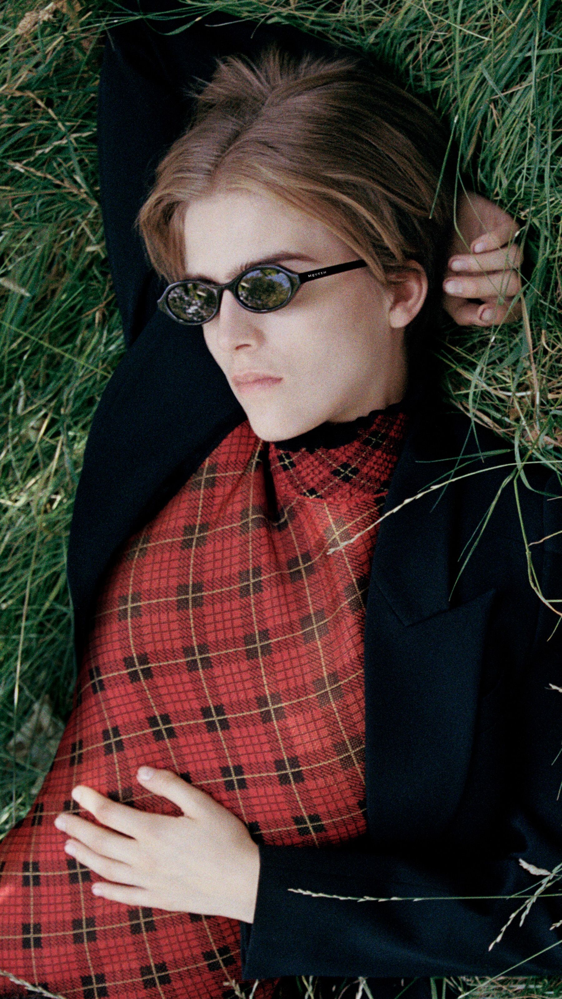 Model wearing a tartan dress and Manta bag with black sunglasses