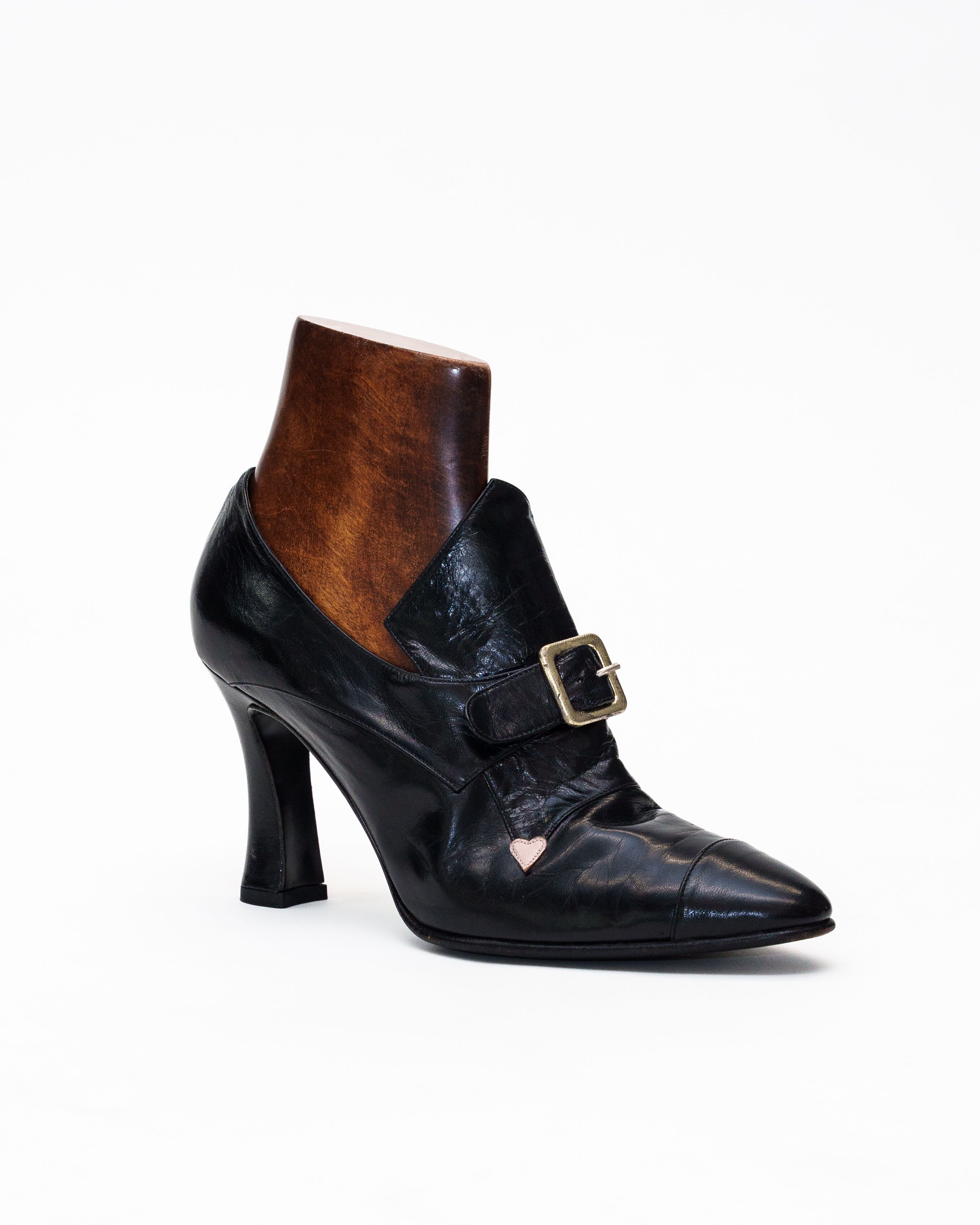 A black shoe with buckle detail