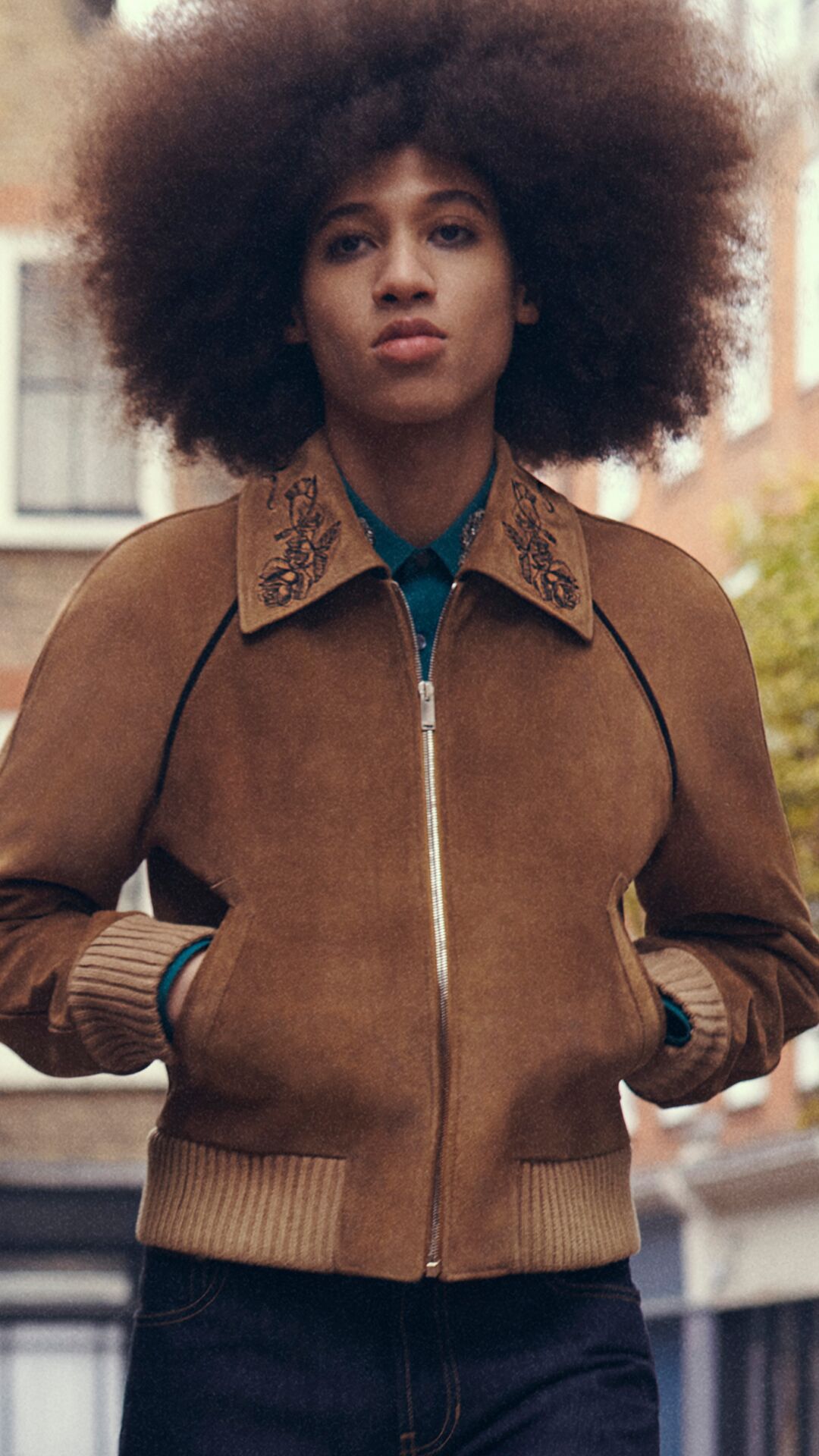 man wearing McQueen brown suede bomber jacket with embellished collar
