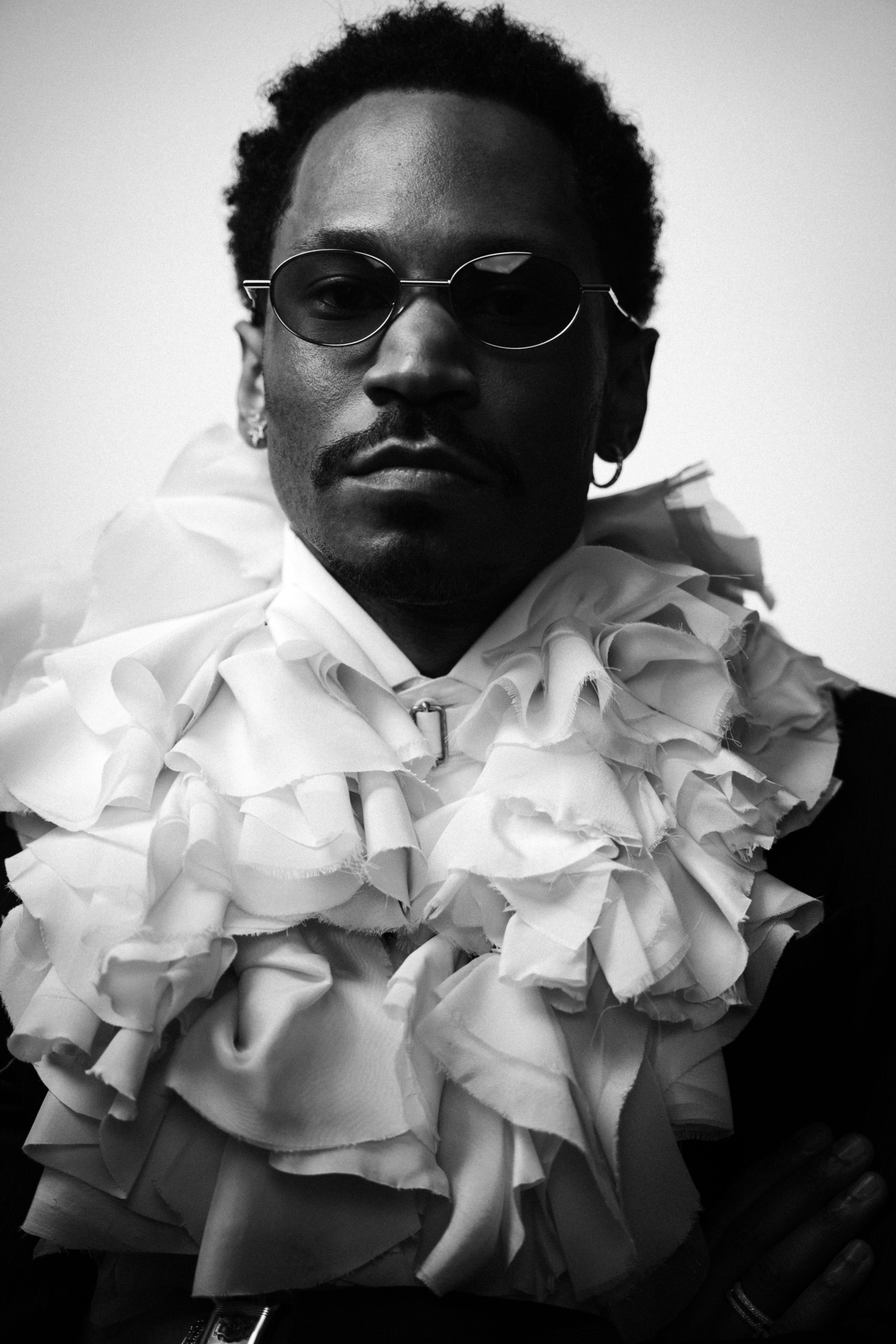 Kaytranada wearing McQueen Autumn Winter 2025 black tailored jacket and ivory-toned ruffle collar shirt to Met Gala 2025
