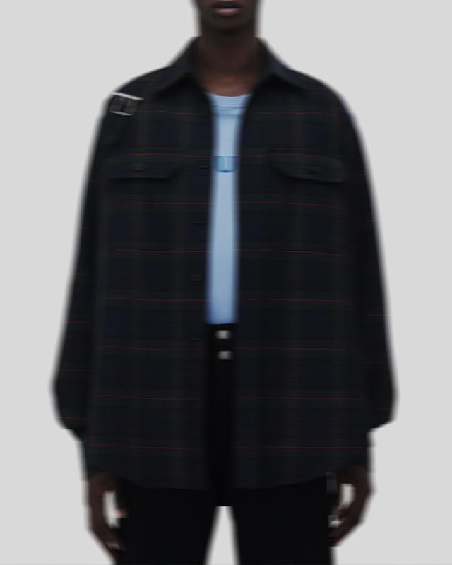 Model wearing McQueen red shirt and shorts, holding McQueen tote bag