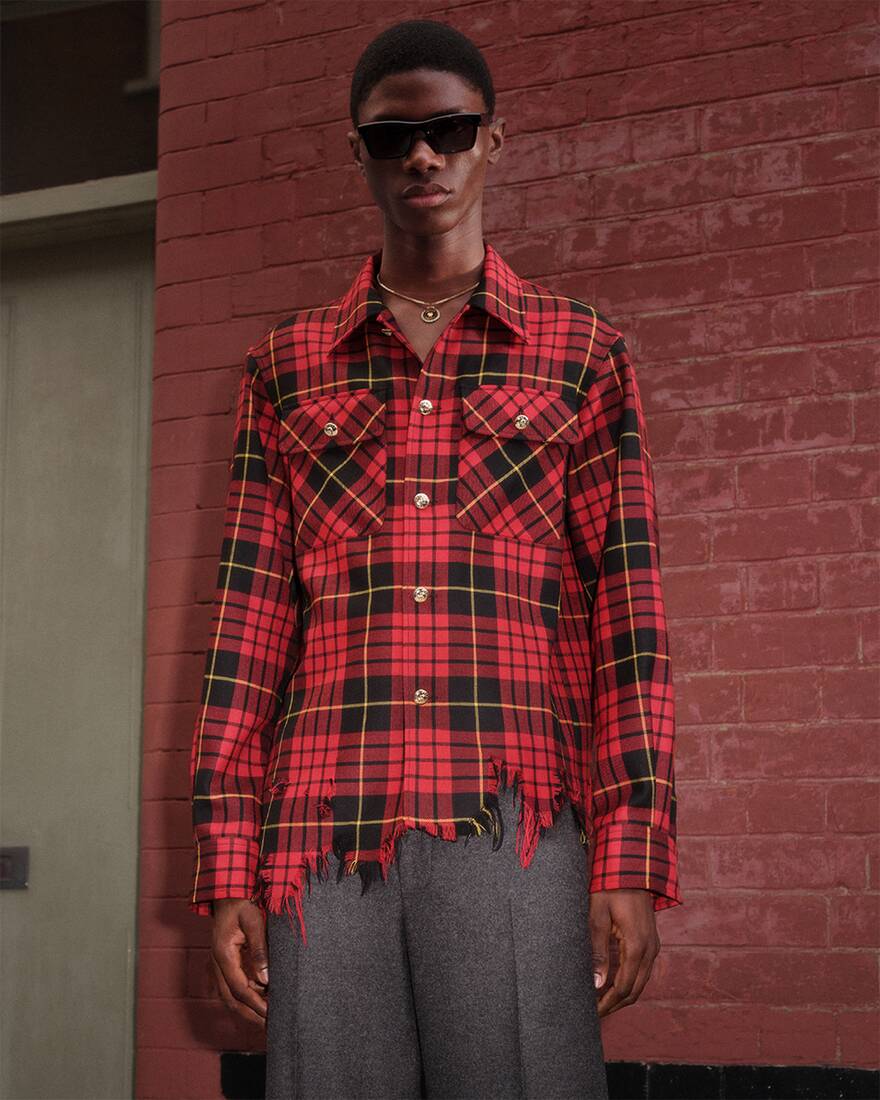 Man wearing macqueen tartan shirt and black sunglasses