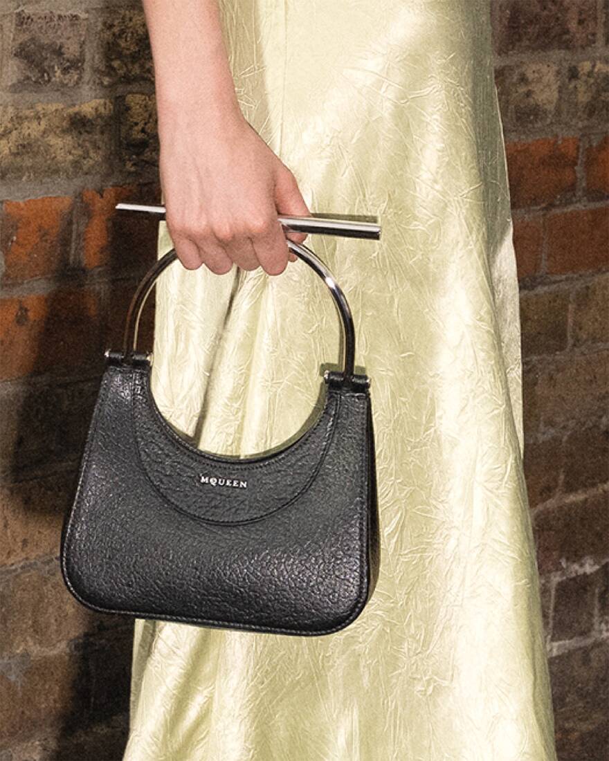 crop image of model holding black bag